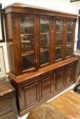 A Victorian mahogany book case cabinet with two pairs of cabinet doors over four drawers and four
