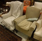 A circa 1900 elbow chair in oatmeal upholstery raised on square tapering legs,