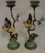 A pair of pottery and brass candlesticks as a bird amongst a flowering branch in the 19th Century