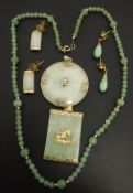 A jade bead necklace, the clasp stamped "1/20 14 kt gf",