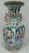 A circa 1900 Chinese famille-rose polychrome decorated vase with panels of figures in interiors