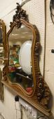 A French carved walnut framed mirror with bevelled glass