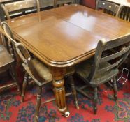 A Victorian mahogany dining table with fluted tapering legs to castors