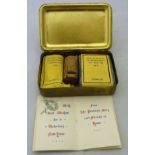 An embossed brass Mary Christmas box containing Christmas cards, cigarettes,