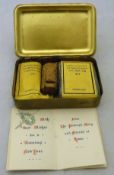 An embossed brass Mary Christmas box containing Christmas cards, cigarettes,