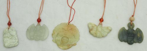 A collection of four modern jade / hard stone carved bat pendants / ornaments,