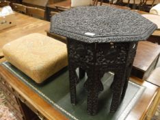 A circa 1900 Indian carved teak and ebonised octagonal occasional table with all over foliate