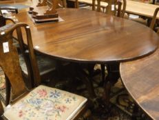 A modern mahogany extending D-end dining table on central pedestal support to quadruped base by