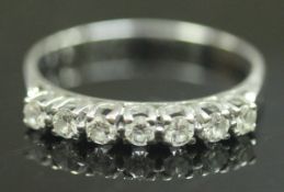 An 18 carat white gold seven stone diamond ring (approx. .