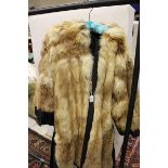 A reversible fox fur jacket with black satin lining