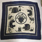 A Hermes silk scarf featuring coaches on a cream and navy ground