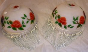 A pair of frosted glass lamp shades with lustre type beaded decoration,