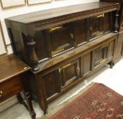 An 18th Century oak court cupboard with two panel doors flanked by baluster turned side pillars