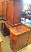 A mahogany kneehole dressing table with bow fronted cupboard doors as drawers and two pot cupboards