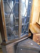 A modern mahogany corner display cabinet