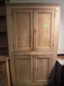 A Victorian pine kitchen cupboard with two pairs of panelled doors (backless)