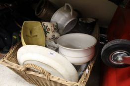 A wicker basket containing various items of chinaware to include jardinieres, serving platters etc.