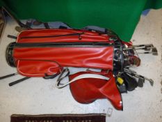 A Dunlop golf bag and trolley and eight various Wilson golf clubs,