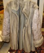 A grey mink lined full length coat CONDITION REPORTS The lining to the coat has