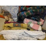 A box containing assorted throws, blankets and table cloths to include a wood type blue,