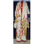A Japanese embroidered Kimono, the cream ground with embroidered red,