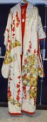 A Japanese embroidered Kimono, the cream ground with embroidered red,