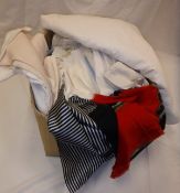 A box of assorted linens to include table cloths etc.