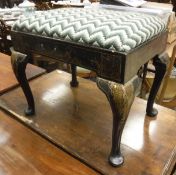 A 19th Century black lacquered and chinoiserie decorated dressing stool on cabriole legs to pad