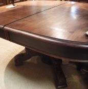 A Continental mahogany D end extending dining table on centre pedestal supports