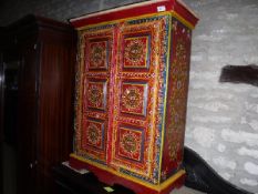 An Indian painted teak two door cupboard