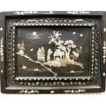 A 19th Century Chinese ebonised and mother of pearl inlaid panel depicting figures in a garden