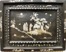 A 19th Century Chinese ebonised and mother of pearl inlaid panel depicting figures in a garden
