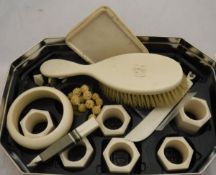 A collection of early 20th Century ivory wares to include napkins rings, cigarette box, hairbrush,