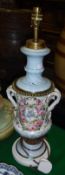 A 19th Century Continental porcelain oil lamp of urn form with polychrome rose and floral