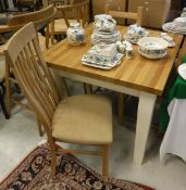 A modern kitchen table with four chairs together with two beech bar stools and two further pine