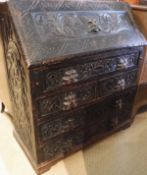 A Victorian Gothic revival carved oak bureau,