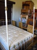 A modern cream painted metal framed and brass embellished four poster bedstead in the Victorian