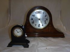 An Edwardian mahogany and inlaid cased mantel clock and an ebony cased mantel clock