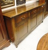 A modern walnut dresser by Browns of Hereford - a plain top with cleated ends over three drawers