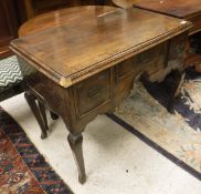 A walnut lowboy with three drawers to cabriole legs