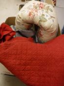 A box of assorted textiles to include a red Durham quilt, bolster cushion,