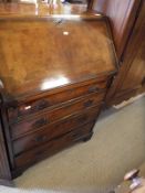 A 20th Century walnut bureau of four long drawers