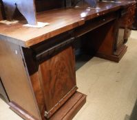 A Victorian mahogany twin pedestal sideboard with central drawer flanked by two pedestal cabinets