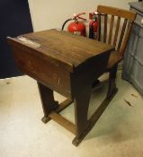 An oak school desk with integral chair