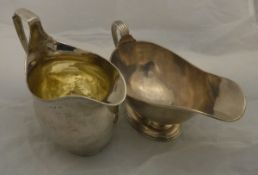 A George III silver cream jug (London 1801) together with a silver sauce boat with reeded rim and