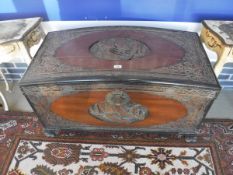 A Chinese camphor wood chest with carved floral and bird decorations and central panel,