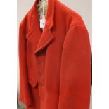 A red hunting coat bearing Beaufort Hunt buttons and label inscribed 'Hand Tailored by Ken Buckland,