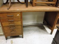 A oak desk with vinyl top and five drawers