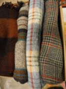 A box containing four wool rugs of brown and green hues bearing Darlington Hall Rug, Sheltand Rug,