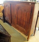 A 19th Century Continental oak cupboard of slim proportions,